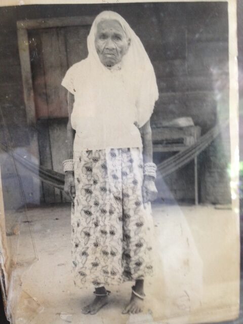 Archival image of Nerina’s great-grandmother, an indentured labourer in Guyana, standing barefoot in a field under the sun